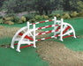Oxers are a set of fences placed several feet apart that give width to an obstacle, encouraging a greater effort from the horse. This wooden jump is painted in colorful red and white.