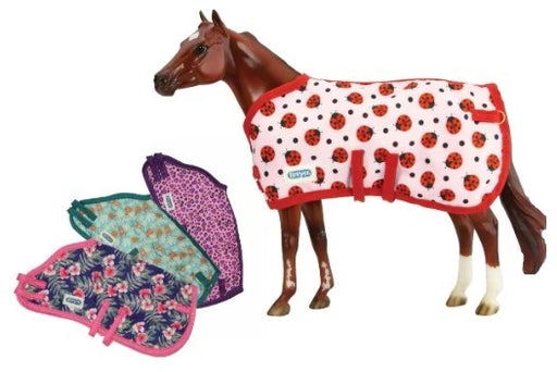 Whether your horse is traveling or standing close to his companions on the shelf, a little protection is often a good thing.  These fabric blankets come in brightly colored patterns with glittery trim, double belly bands and chest closures.