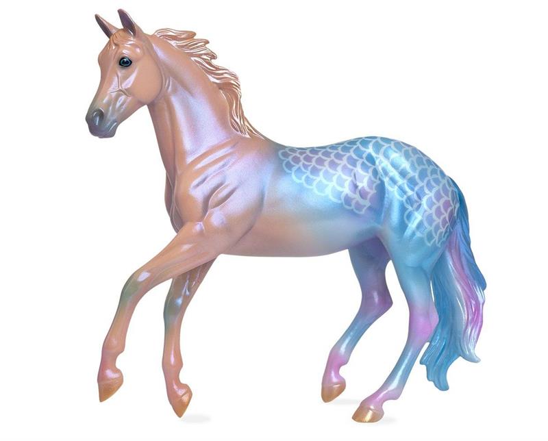 Coras pearly pastel coat begins as pinky purple and deepens to a gorgeous inky blue and purple, bringing to mind the natural iridescence and coloring of seashells. Her beautiful look is completed with golden hooves.