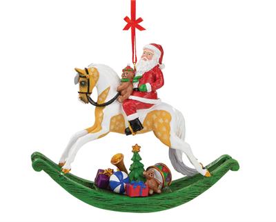 Breyer Horses 2021 Holiday Christmas Rocking Horse Santa Ornament #700715 This rocking horse ornament harkens back to the days of old! Santa sits astride a beautiful palomino pinto rocking horse with a teddy bear, and has brought a colorful pile of gifts with him.