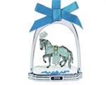 Breyer’s 2018 Stirrup Ornament features a finely-detailed miniature of the 2018 Holiday Horse, “Celestine.” She is framed inside a classic silver-tone stirrup that has a crystal snowflake dangling from its top. This glittering ornament hangs from a blue r